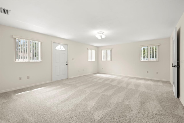 5800 3rd St S, Saint Petersburg, FL 33705 - unfurnished room with healthy amount of natural light and light colored carpet