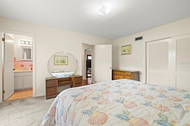 5800 3rd St S, Saint Petersburg, FL 33705 - carpeted bedroom featuring a closet and ensuite bath