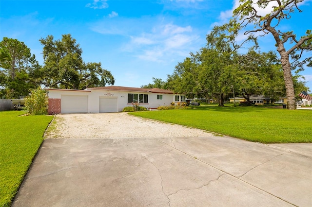 5800 3rd St S, Saint Petersburg, FL 33705 - single story home with driveway, a front lawn, stucco siding, and an attached garage