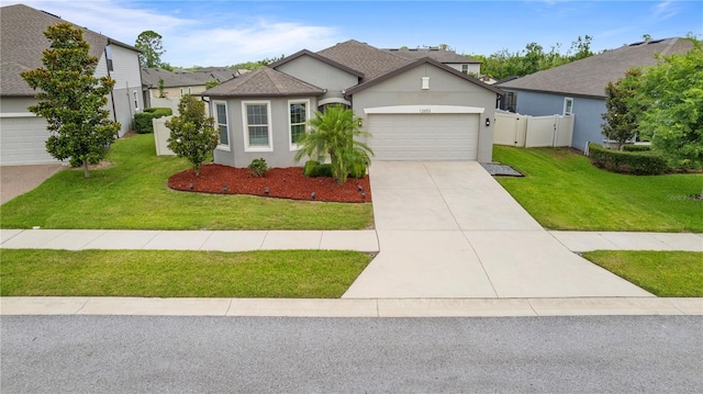 12653 Palapa Loop, Spring Hill, FL 34610 - view of front facade with an attached garage, stucco siding, driveway, and a gate