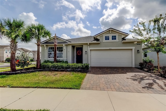 2456 Arbor Wind Dr, Lutz, FL 33558 - view of front of house featuring stucco siding, decorative driveway, a garage, and a front lawn