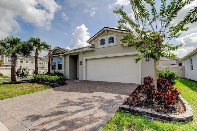 2456 Arbor Wind Dr, Lutz, FL 33558 - view of front facade featuring stucco siding, a garage, and decorative driveway