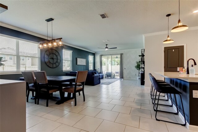 2456 Arbor Wind Dr, Lutz, FL 33558 - dining space featuring crown molding, ceiling fan, and a textured ceiling