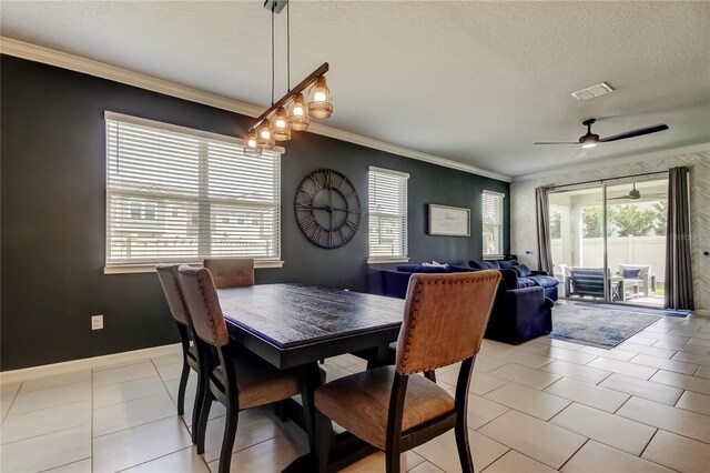 2456 Arbor Wind Dr, Lutz, FL 33558 - dining area featuring crown molding, light tile patterned floors, ceiling fan, a textured ceiling, and baseboards
