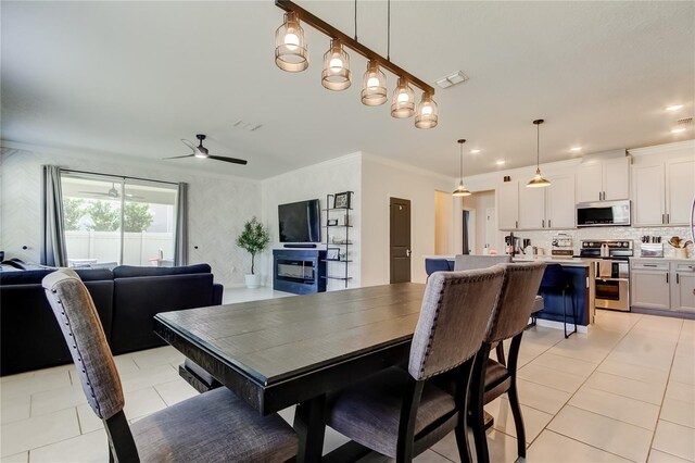 2456 Arbor Wind Dr, Lutz, FL 33558 - dining room with ceiling fan, light tile patterned flooring, and crown molding