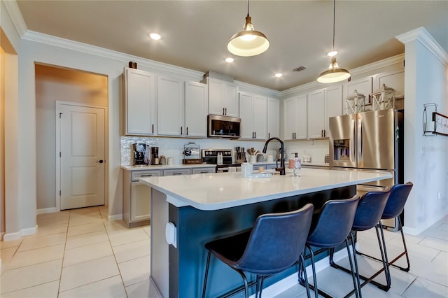 2456 Arbor Wind Dr, Lutz, FL 33558 - kitchen with stainless steel appliances, light tile patterned flooring, baseboards, a kitchen bar, and light countertops