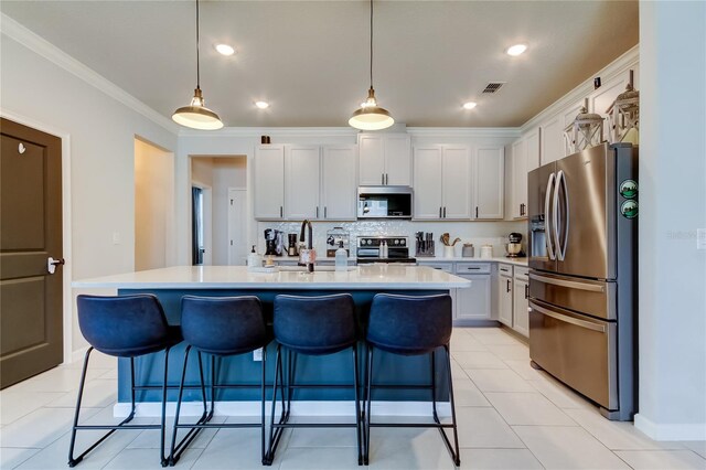 2456 Arbor Wind Dr, Lutz, FL 33558 - kitchen featuring appliances with stainless steel finishes, light countertops, a breakfast bar, a sink, and a center island with sink