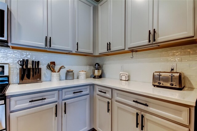 2456 Arbor Wind Dr, Lutz, FL 33558 - kitchen with backsplash, light countertops, and range