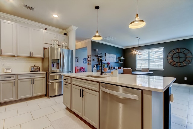 2456 Arbor Wind Dr, Lutz, FL 33558 - kitchen featuring stainless steel appliances, a sink, crown molding, light countertops, and hanging light fixtures