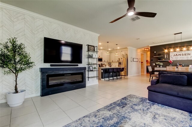 2456 Arbor Wind Dr, Lutz, FL 33558 - living room with wallpapered walls, crown molding, baseboards, ceiling fan, and light tile patterned floors