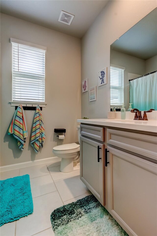 2456 Arbor Wind Dr, Lutz, FL 33558 - full bathroom with vanity, toilet, tile patterned flooring, and curtained shower