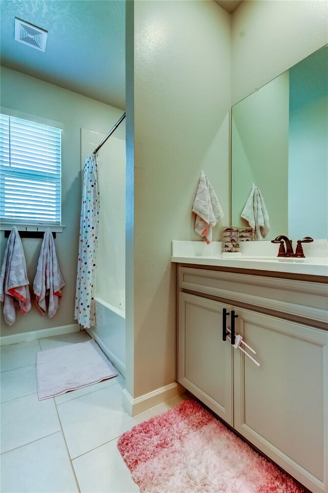 2456 Arbor Wind Dr, Lutz, FL 33558 - full bathroom featuring vanity, shower / tub combo, tile patterned floors, and baseboards