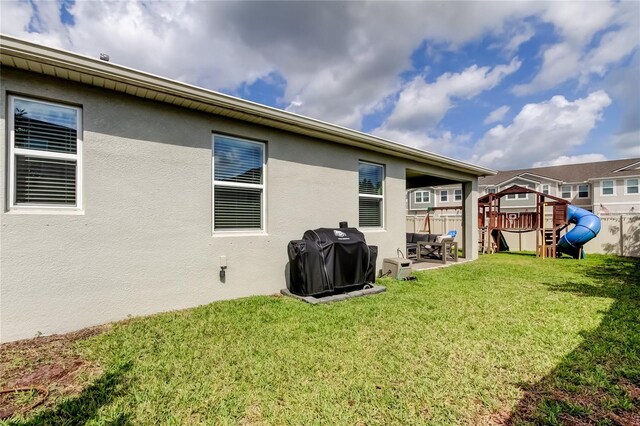2456 Arbor Wind Dr, Lutz, FL 33558 - back of property featuring a playground, a patio, and stucco siding
