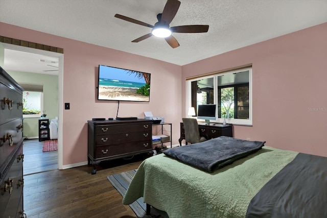 3229 40th Ln S Unit C, Saint Petersburg, FL 33711 - bedroom with dark wood-type flooring, baseboards, a textured ceiling, and a ceiling fan