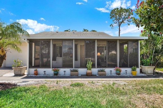 3229 40th Ln S Unit C, Saint Petersburg, FL 33711 - rear view of house featuring a sunroom and a garage