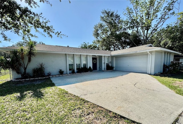 4128 Palo Alto Dr, Lakeland, FL 33813 - view of front of property featuring stucco siding, driveway, an attached garage, and a front yard