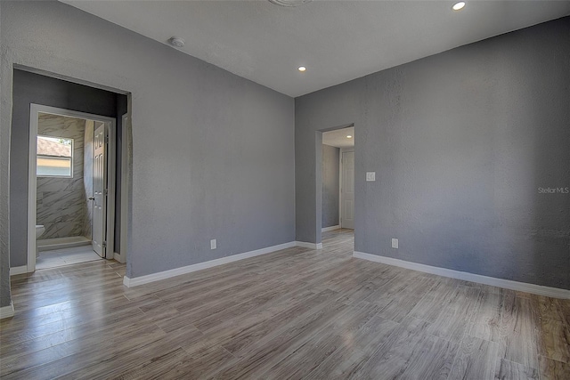 2627 17th Ave N, Saint Petersburg, FL 33713 - empty room with wood finished floors, baseboards, a smoke detector, and recessed lighting