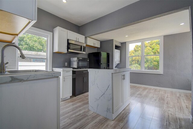 2627 17th Ave N, Saint Petersburg, FL 33713 - kitchen featuring stainless steel microwave, freestanding refrigerator, a sink, plenty of natural light, and recessed lighting
