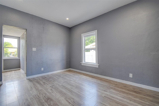 2627 17th Ave N, Saint Petersburg, FL 33713 - spare room featuring wood finished floors, a textured wall, baseboards, and recessed lighting