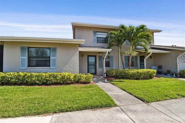 2131 Ridge Rd S Unit 3, Largo, FL 33778 - view of front of house with stucco siding and a front lawn
