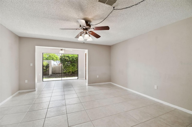 2131 Ridge Rd S Unit 3, Largo, FL 33778 - spare room featuring ceiling fan, a textured ceiling, light tile patterned flooring, and baseboards