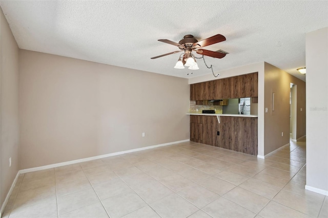 2131 Ridge Rd S Unit 3, Largo, FL 33778 - kitchen featuring stainless steel fridge with ice dispenser, brown cabinetry, light countertops, backsplash, and ceiling fan