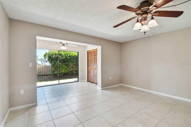 2131 Ridge Rd S Unit 3, Largo, FL 33778 - spare room with a textured ceiling, light tile patterned floors, a ceiling fan, and baseboards