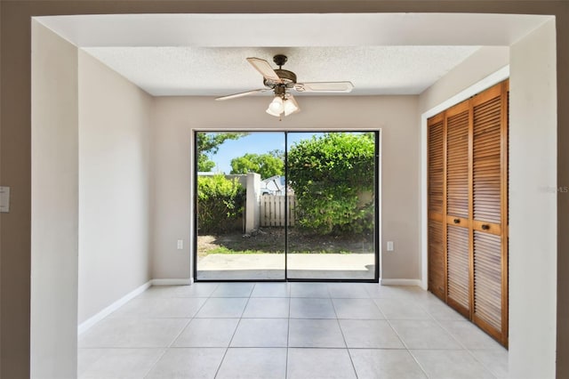 2131 Ridge Rd S Unit 3, Largo, FL 33778 - unfurnished bedroom with access to outside, baseboards, light tile patterned floors, a textured ceiling, and a closet