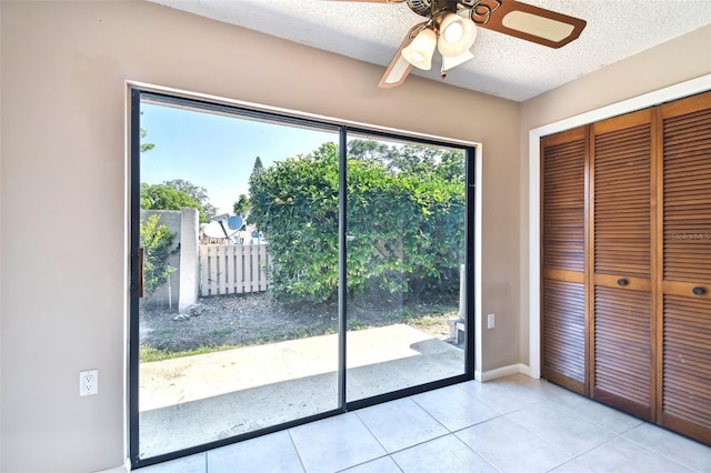 2131 Ridge Rd S Unit 3, Largo, FL 33778 - doorway to outside with a ceiling fan, tile patterned floors, a textured ceiling, and baseboards