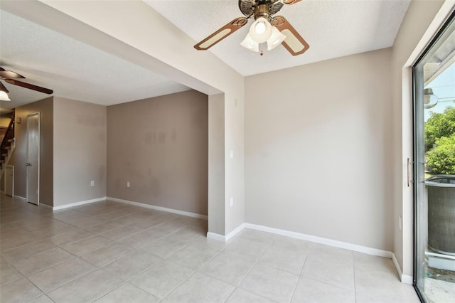 2131 Ridge Rd S Unit 3, Largo, FL 33778 - unfurnished room with a ceiling fan, light tile patterned floors, a textured ceiling, stairs, and baseboards