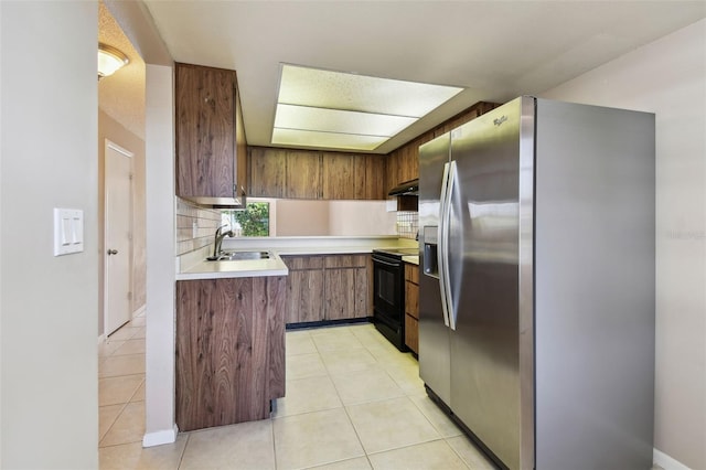 2131 Ridge Rd S Unit 3, Largo, FL 33778 - kitchen featuring stainless steel fridge, black range with electric stovetop, a sink, under cabinet range hood, and light countertops