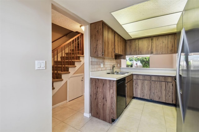 2131 Ridge Rd S Unit 3, Largo, FL 33778 - kitchen with freestanding refrigerator, dishwasher, tasteful backsplash, a sink, and light countertops