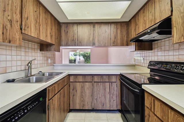 2131 Ridge Rd S Unit 3, Largo, FL 33778 - kitchen with black appliances, under cabinet range hood, a sink, and light countertops