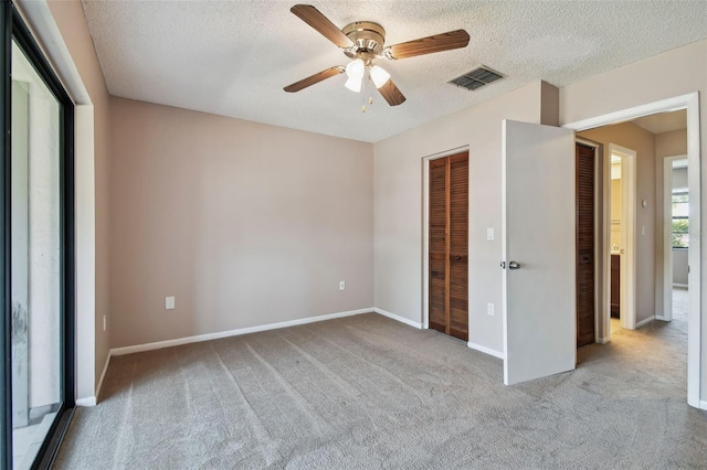 2131 Ridge Rd S Unit 3, Largo, FL 33778 - unfurnished bedroom with carpet floors, a closet, a textured ceiling, baseboards, and a ceiling fan