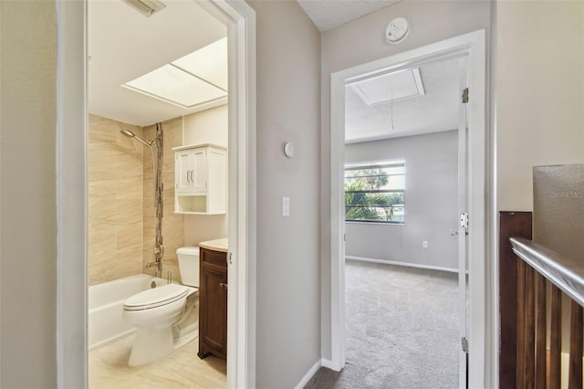 2131 Ridge Rd S Unit 3, Largo, FL 33778 - full bathroom with toilet, vanity,  shower combination, a textured ceiling, and baseboards