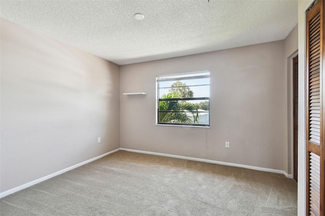 2131 Ridge Rd S Unit 3, Largo, FL 33778 - carpeted spare room featuring a textured ceiling and baseboards