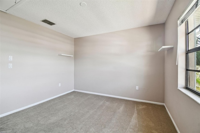 2131 Ridge Rd S Unit 3, Largo, FL 33778 - spare room featuring healthy amount of natural light, carpet, baseboards, and a textured ceiling