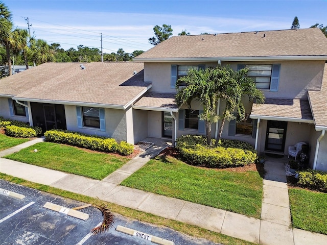 2131 Ridge Rd S Unit 3, Largo, FL 33778 - townhome / multi-family property with stucco siding, a front lawn, uncovered parking, and a shingled roof