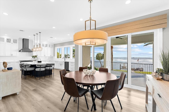 110 Carlyle Dr, Palm Harbor, FL 34683 - dining room with a water view, light wood-style flooring, and recessed lighting