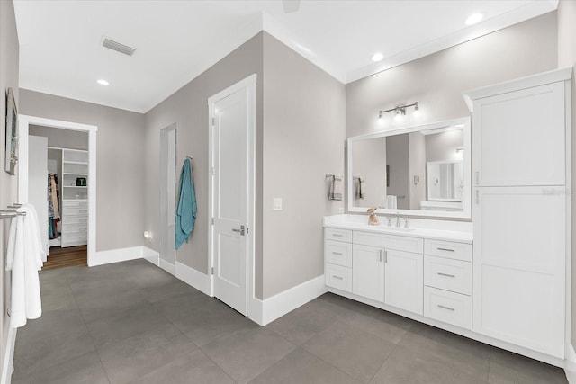 110 Carlyle Dr, Palm Harbor, FL 34683 - bathroom featuring vanity, a walk in closet, and recessed lighting