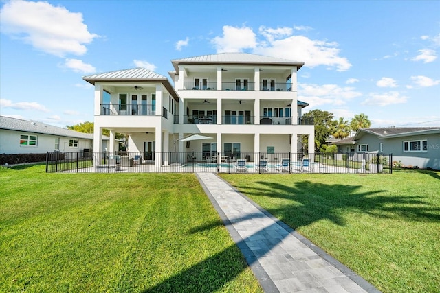 110 Carlyle Dr, Palm Harbor, FL 34683 - back of house with a balcony, a ceiling fan, stucco siding, and a patio