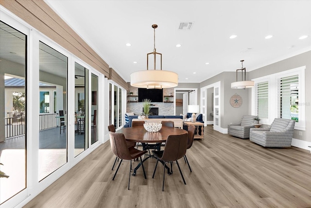 110 Carlyle Dr, Palm Harbor, FL 34683 - dining area featuring light wood finished floors, healthy amount of natural light, recessed lighting, and crown molding