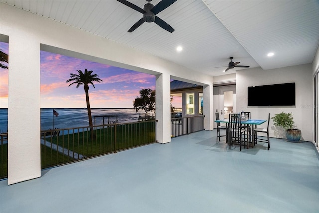110 Carlyle Dr, Palm Harbor, FL 34683 - view of patio with a ceiling fan, outdoor dining area, and a water view