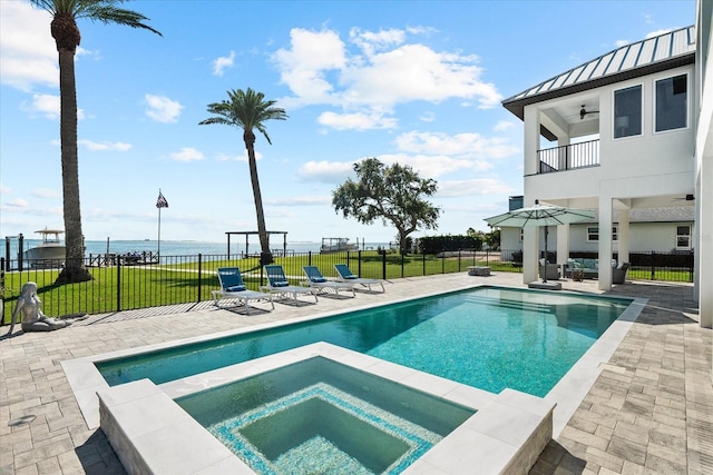 110 Carlyle Dr, Palm Harbor, FL 34683 - view of pool with ceiling fan, a patio area, a water view, and a pool with connected hot tub