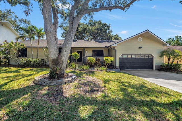 7461 Pescador Pl, Seminole, FL 33772 - ranch-style home with an attached garage, a front yard, driveway, and covered porch