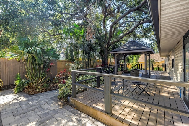 7461 Pescador Pl, Seminole, FL 33772 - wooden terrace with a gazebo, a fenced backyard, outdoor dining space, and a patio area
