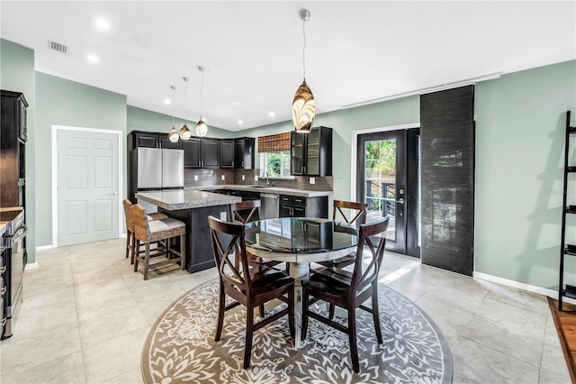 7461 Pescador Pl, Seminole, FL 33772 - dining area featuring baseboards, recessed lighting, light tile patterned floors, and vaulted ceiling