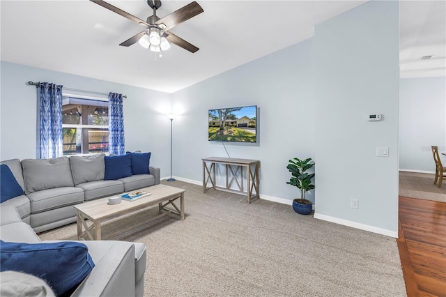 7461 Pescador Pl, Seminole, FL 33772 - living room featuring ceiling fan, lofted ceiling, baseboards, and carpet flooring