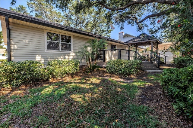7461 Pescador Pl, Seminole, FL 33772 - rear view of property with a wooden deck and a chimney