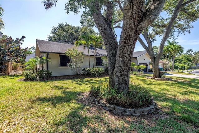 7461 Pescador Pl, Seminole, FL 33772 - view of home's exterior featuring a yard and roof with shingles